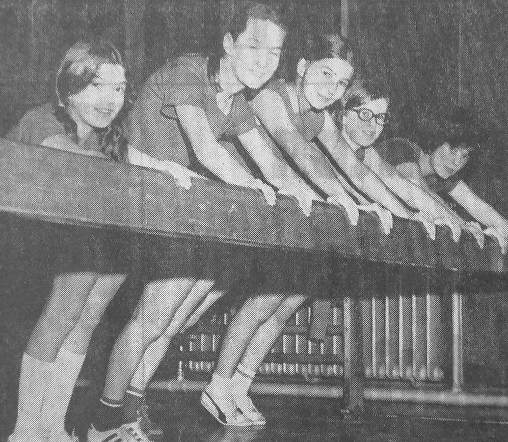 Members of the junior section of Wallasey Athletic Club limbering up during a training session at Wallasey Technical Grammar School.